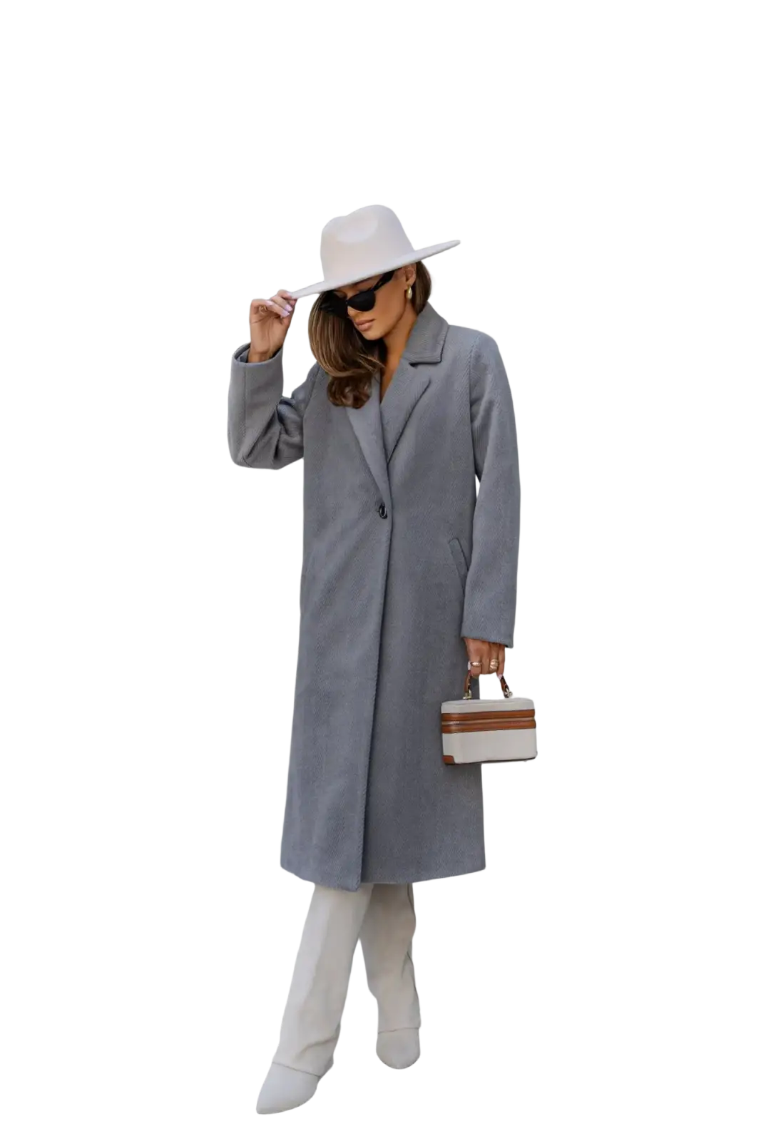 White minimalist handbag with tan leather trim and structured shape complementing a red wool trench coat for office wear