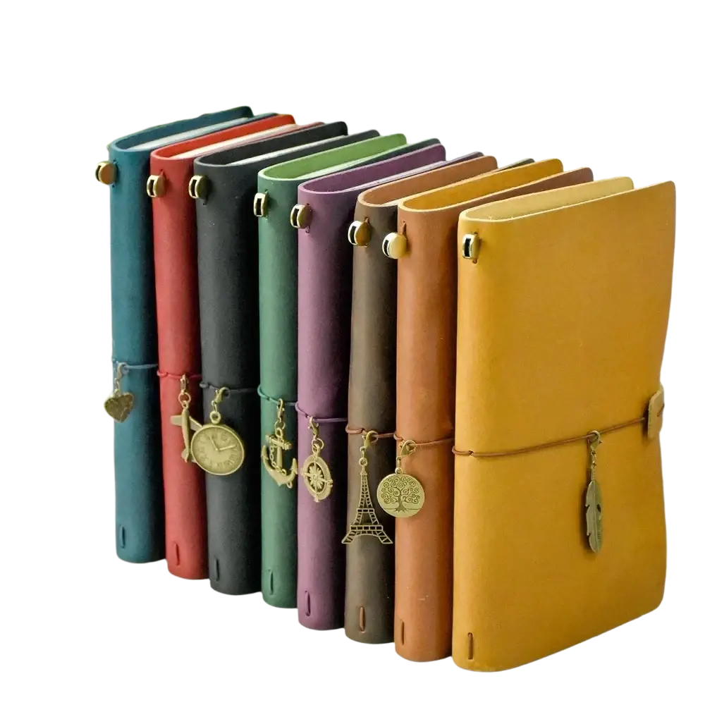 A collection of colorful refillable genuine leather travel journal notebooks with unique metallic charms