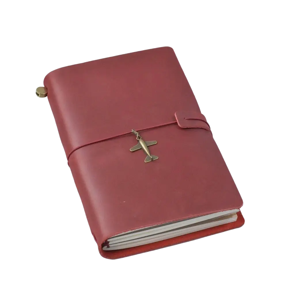 Refillable genuine leather travel journal notebook in red with brass airplane charm on elastic strap