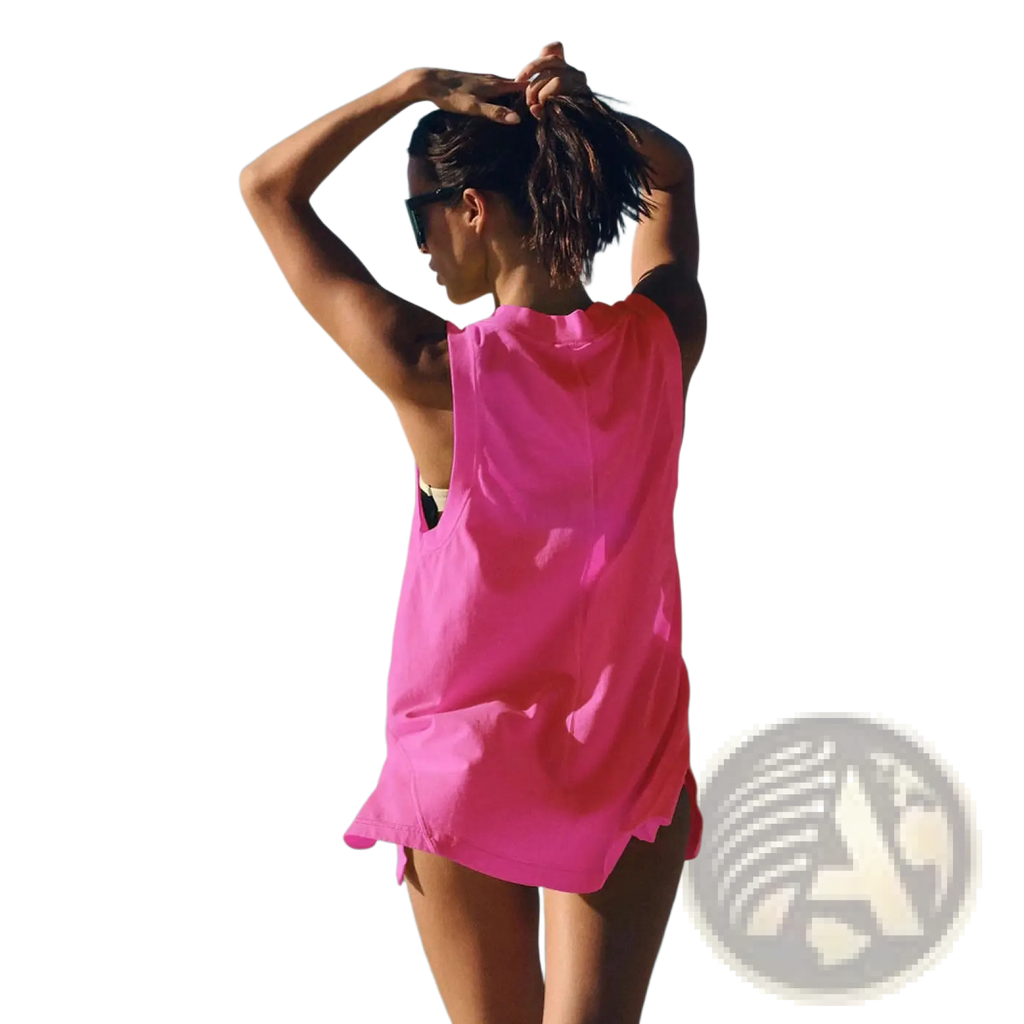 A vibrant pink sleeveless cotton wrap vest top with a relaxed v neck and flowing silhouette ideal for beachwear