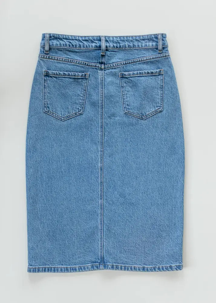 Remi classic wash stretch denim midi skirt in light blue showing the back design with two pockets and button closure