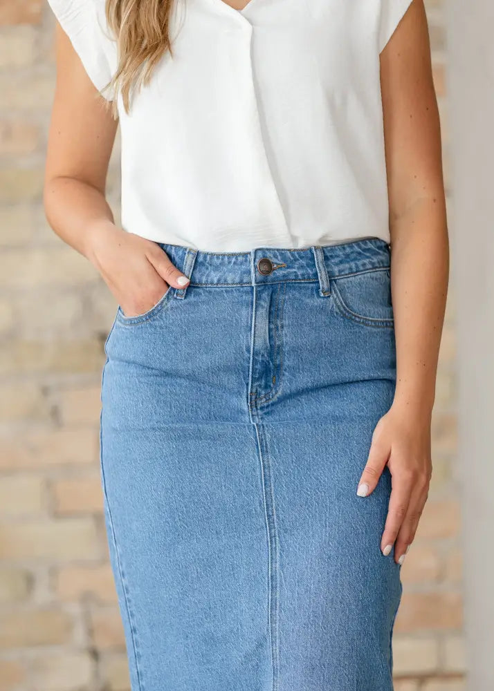 Remi classic wash stretch denim midi skirt in medium blue with visible stitching and belt loops mid-thigh length