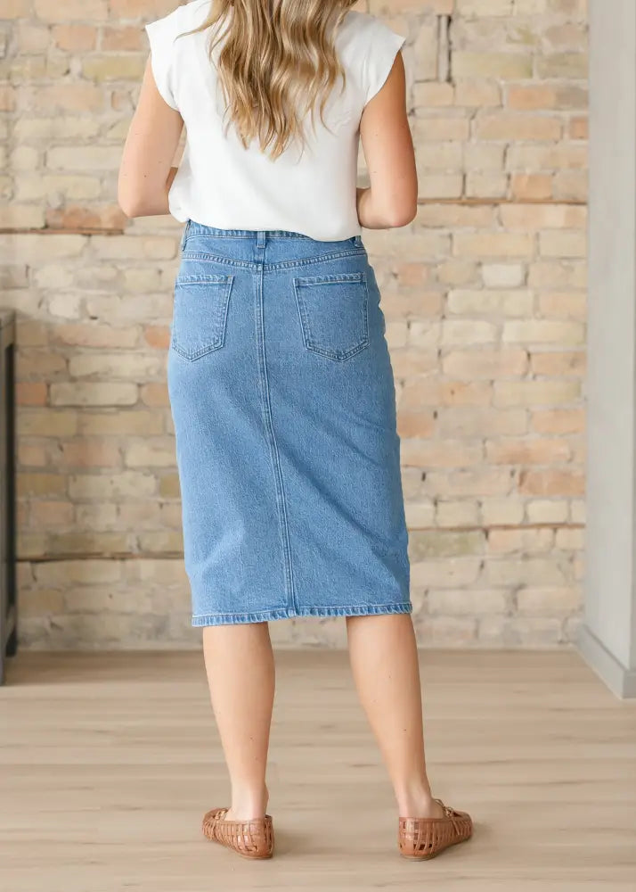 Remi classic wash stretch denim midi skirt in faded blue with two back pockets shown from the back side