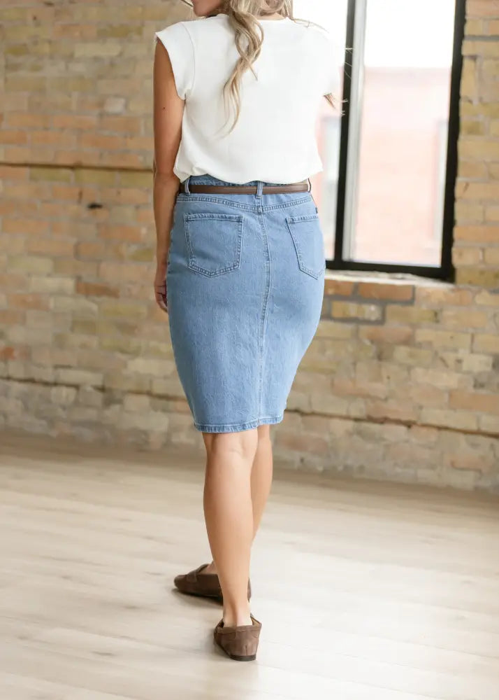 Remi classic wash stretch denim midi skirt in light-wash denim shows back side with classic pockets and belt loop waistband