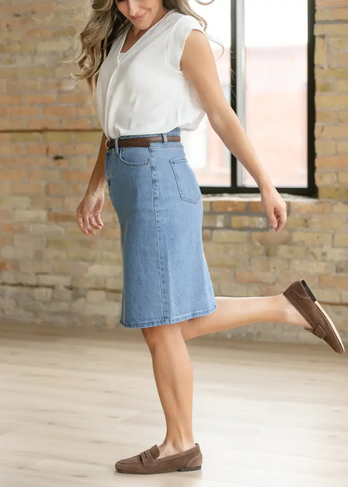 A light blue stretch cotton denim midi skirt with a classic fit and front pockets from Remi Classic Wash collection