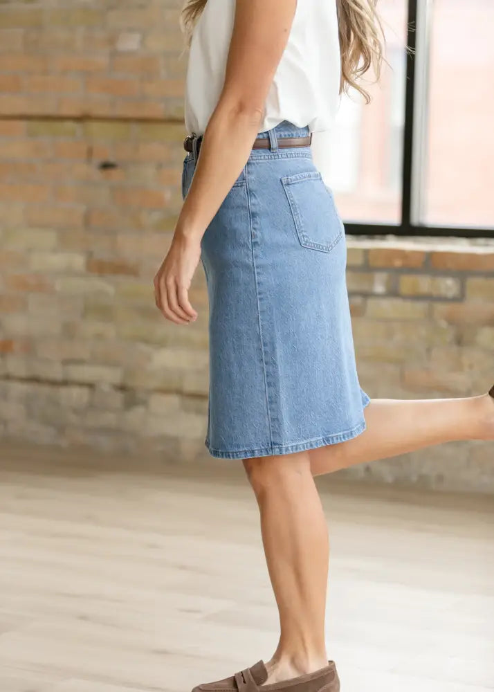 Light-wash denim a-line midi skirt showing back side with classic pocket and belt loop from Remi classic wash stretch series