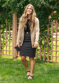 Black textured clutch purse paired with remi onyx black no slit stretch denim midi skirt front view
