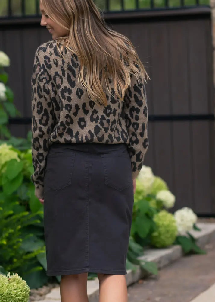 A black denim pencil skirt with a fitted silhouette and front pockets from Remi Onyx Black no slit stretch collection