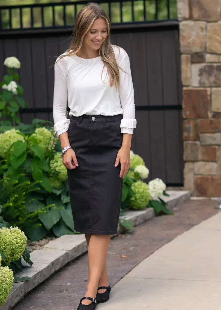 Black knee-length Remi Onyx pencil skirt with classic waistband and subtle stitching in stretch denim fabric