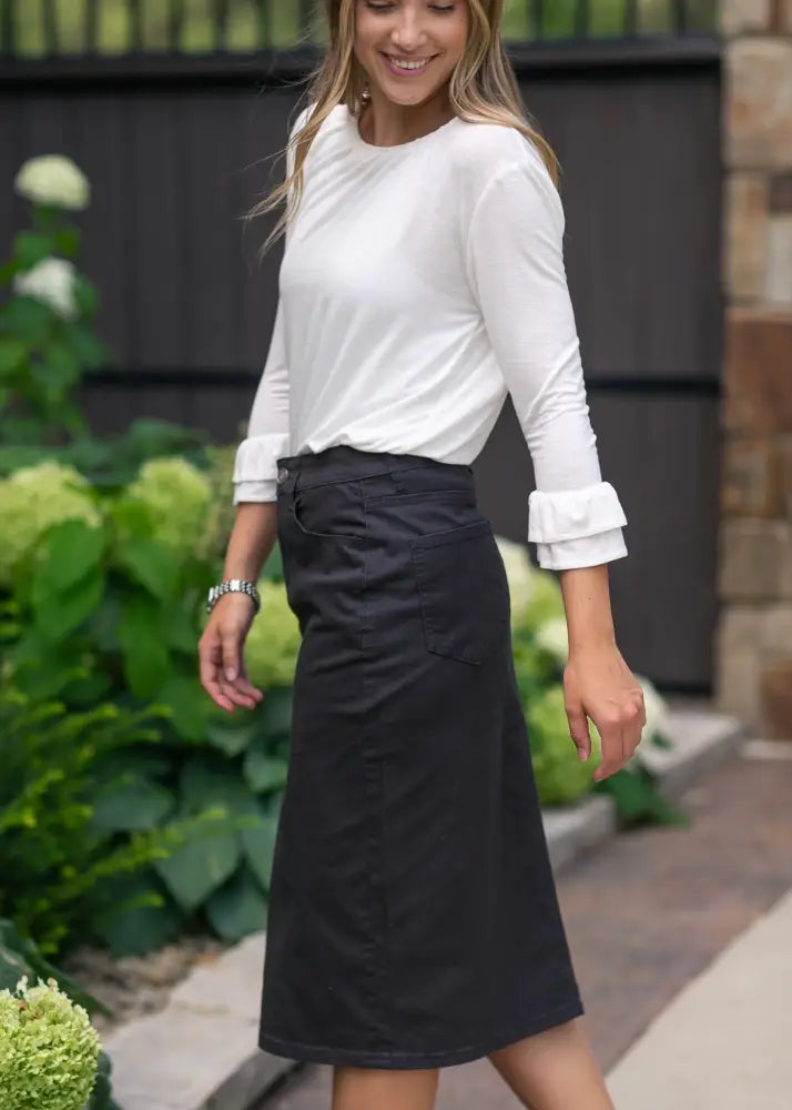 Remi Onyx black no slit stretch denim midi skirt with straight cut and subtle front pocket detail