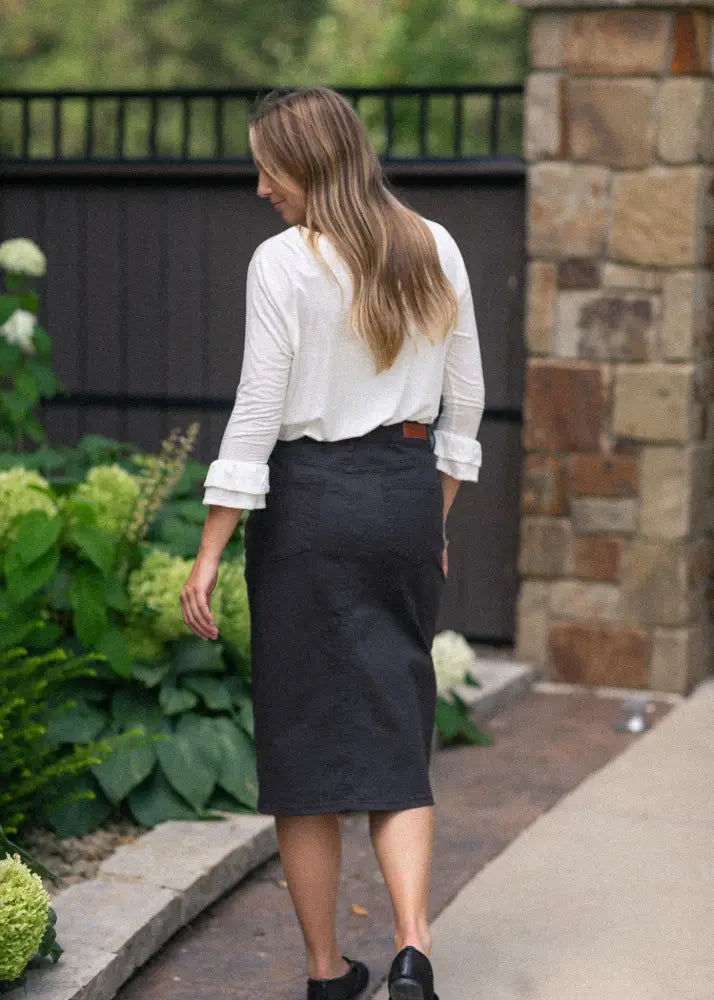 Black Remi Onyx stretch denim midi pencil skirt with straight cut and subtle pleats at waistband