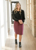 Remi Orchid burgundy denim midi skirt with a fitted knee-length pencil silhouette and subtle front seam detail