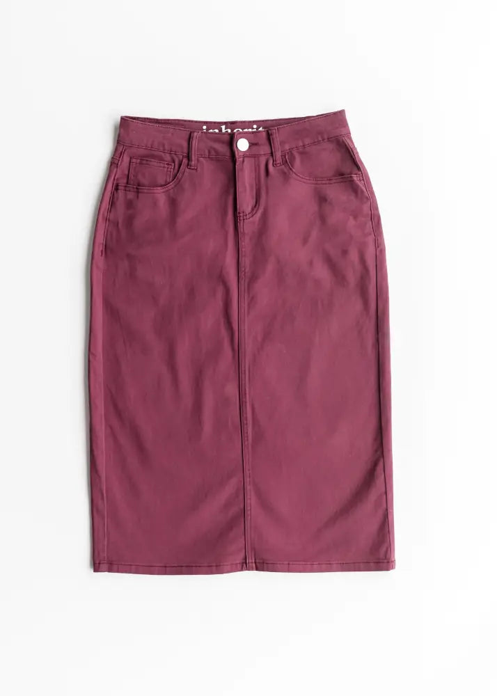 A maroon denim midi skirt with a straight cut and front zipper closure from Remi Orchid Burgundy Denim Midi Skirt