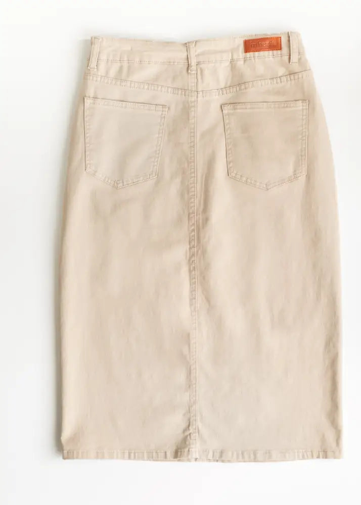 Beige denim midi skirt with back pockets and brown leather Remi brand patch shown from the back side