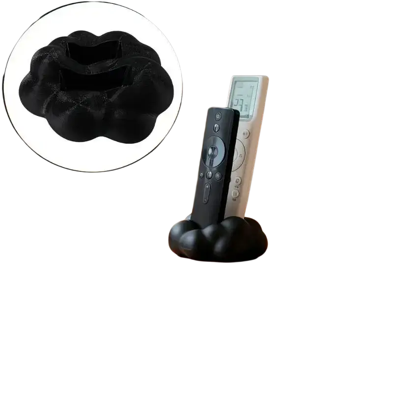 Black cloud-shaped remote control holder with soft textured surface for organized desktop storage and easy access
