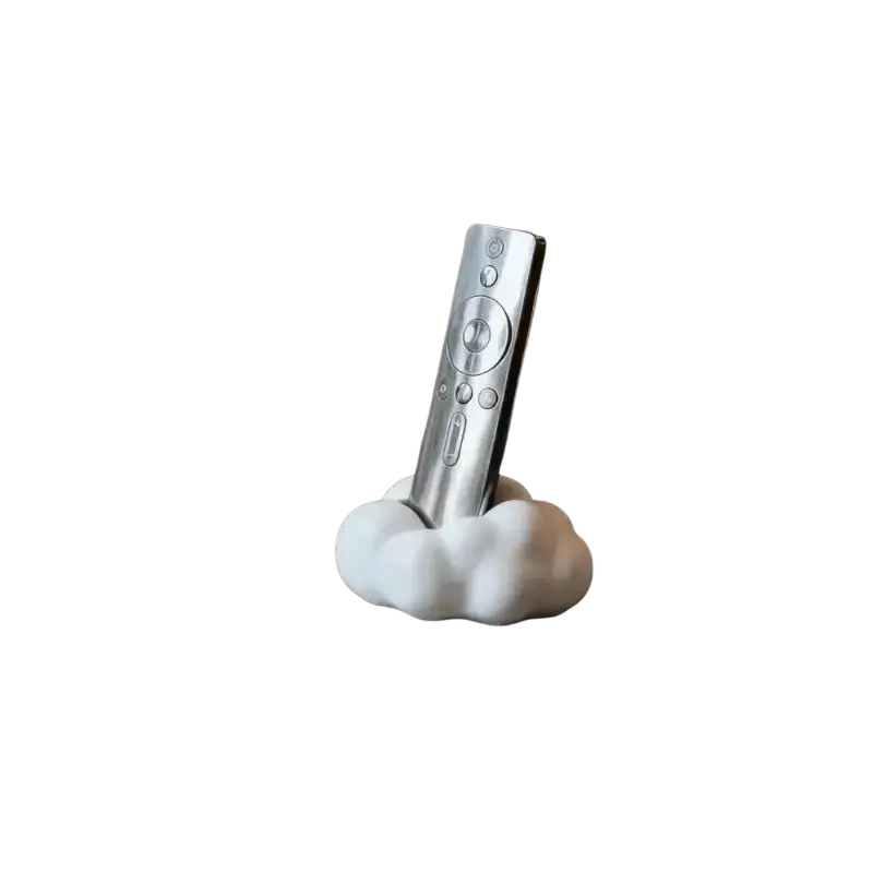 Silver remote control resting in a white cloud-shaped remote control holder for organized living rooms