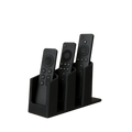 Black plastic remote control organizer with three slots holding different black tv remotes for easy storage