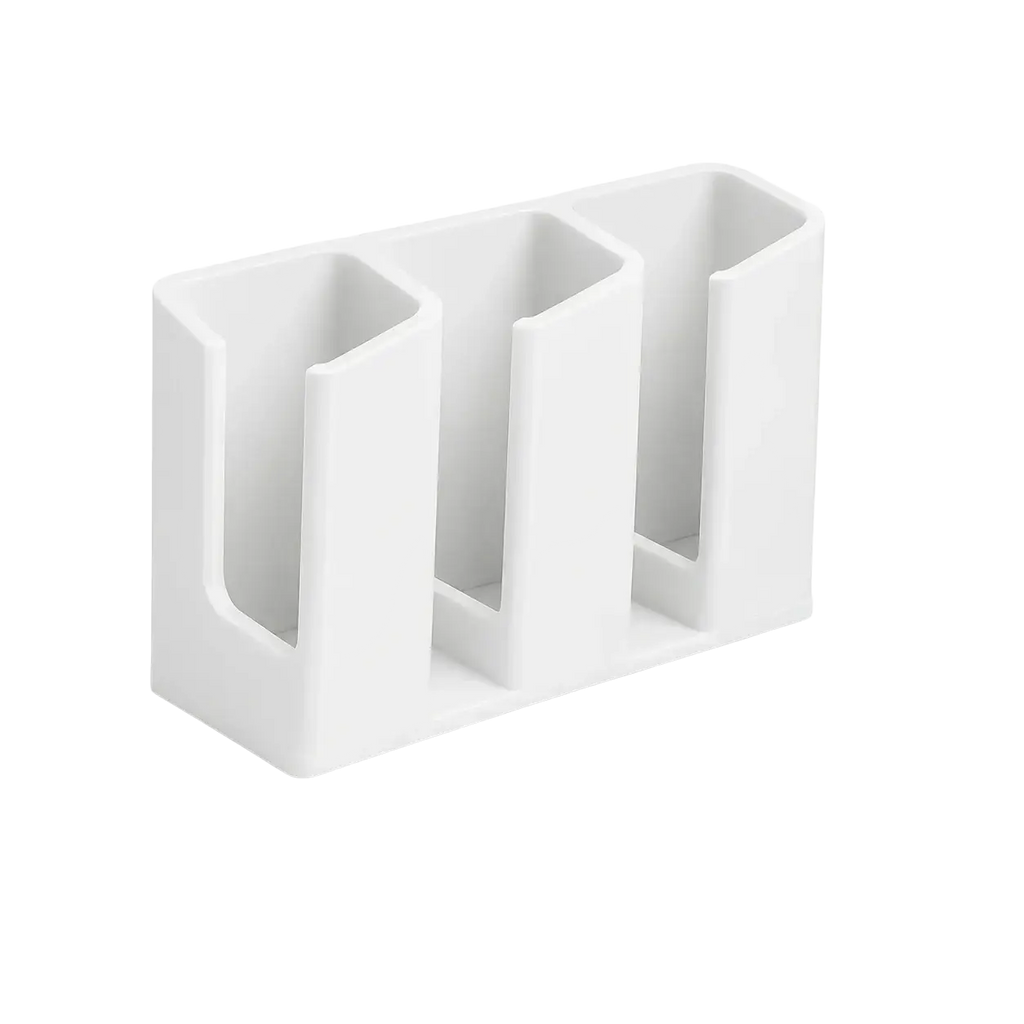 White plastic remote control organizer with three rectangular slots for holding devices and small items