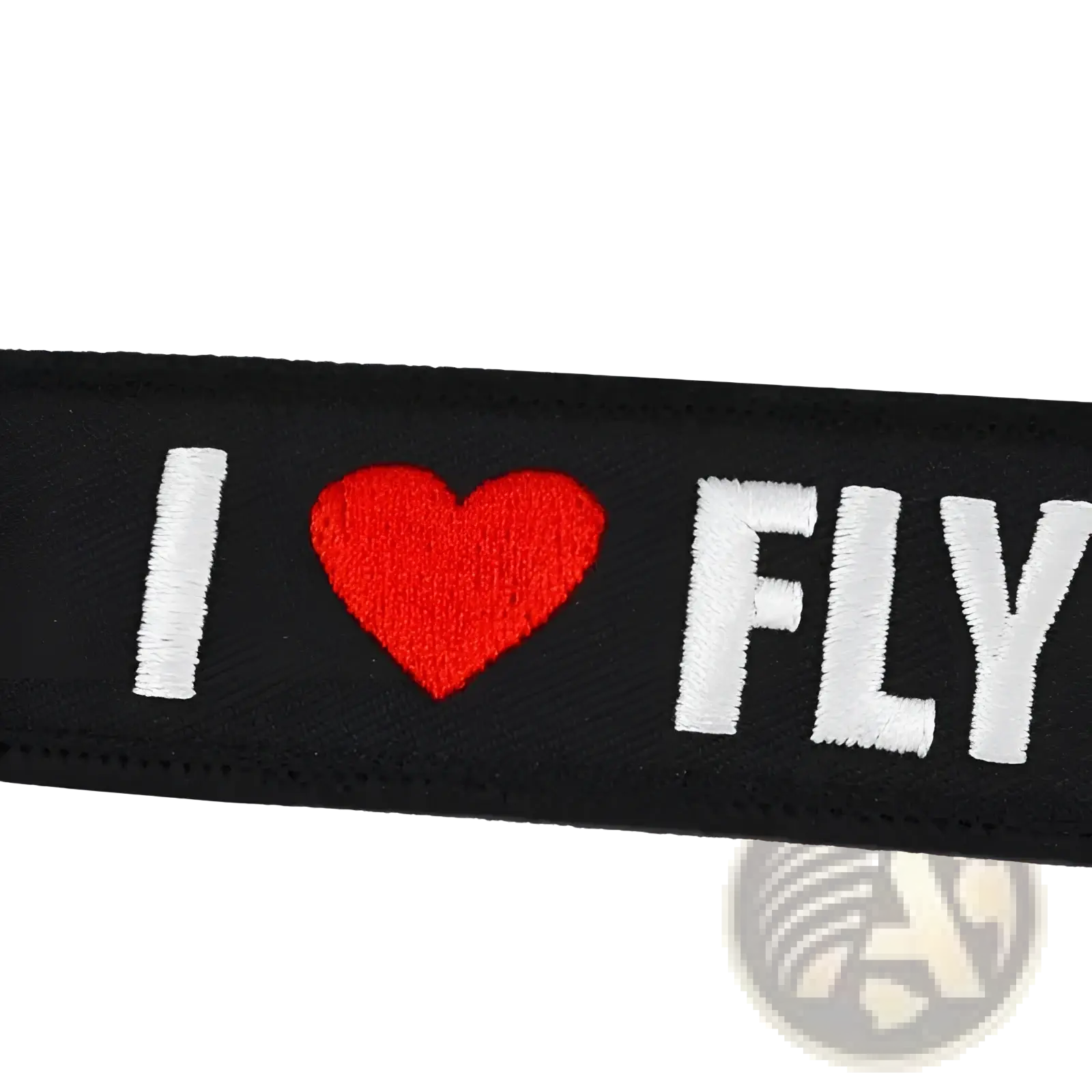 Black embroidered patch keychain with white i heart fly lettering and red heart symbol for remove before flight use