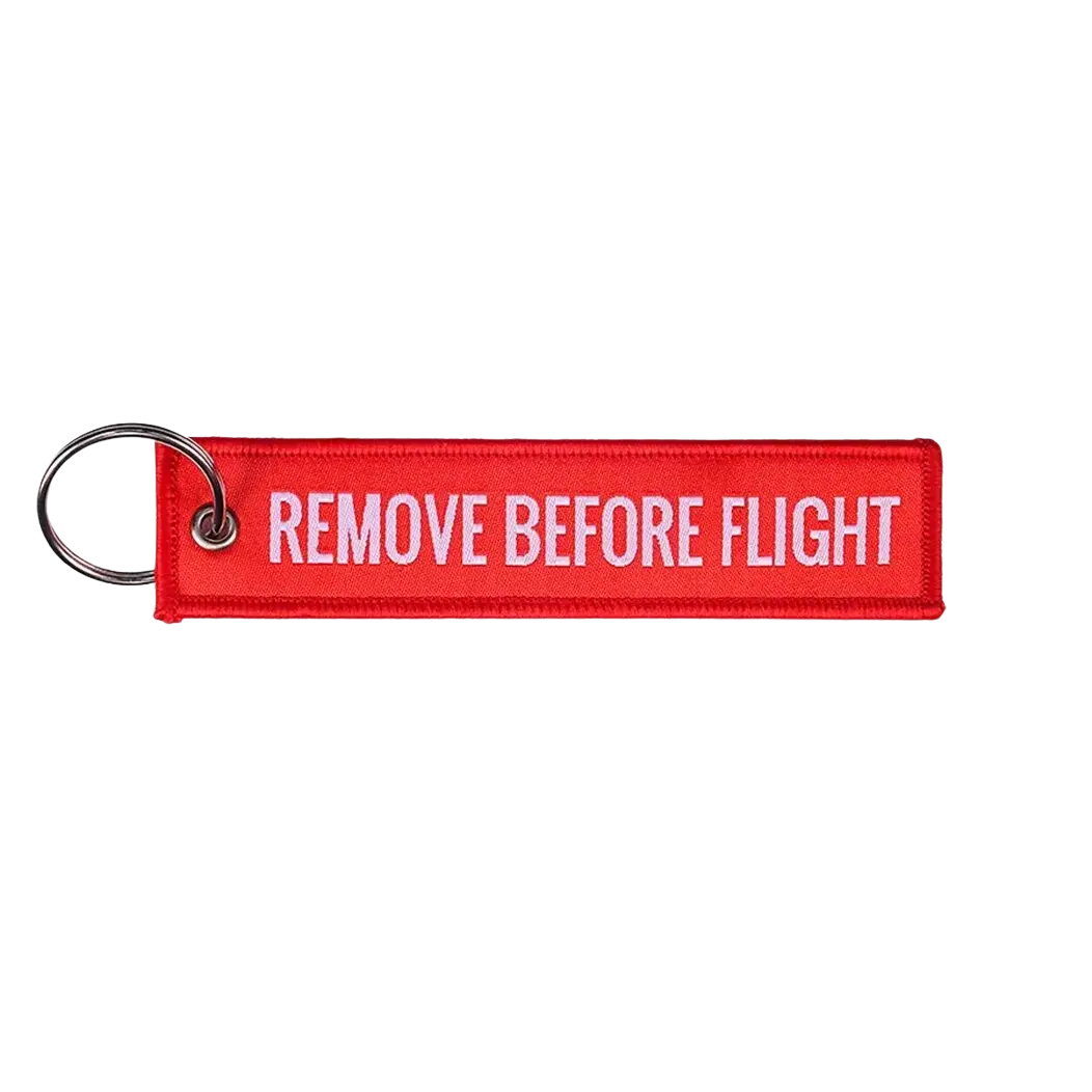 Remove before flight embroidered keychain in red with white text and metal ring for aviation safety use