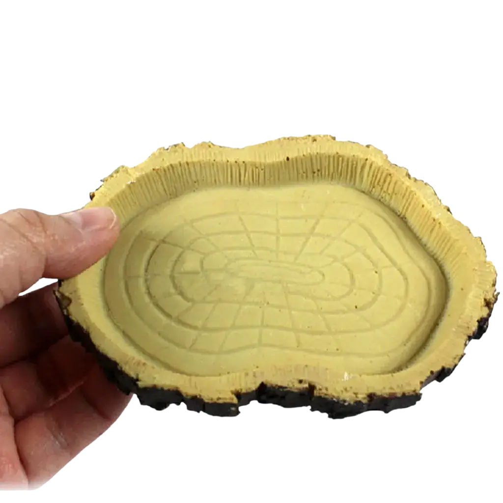 Yellow resin reptile feeding bowl shaped like a tree slice with realistic bark texture and concentric rings