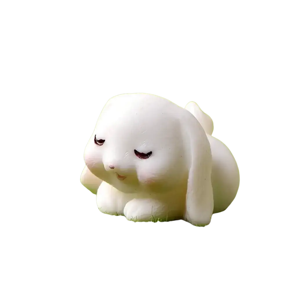 Cute white resin bunny figurine with soft rounded features and closed eyes for easter garden and cake decor