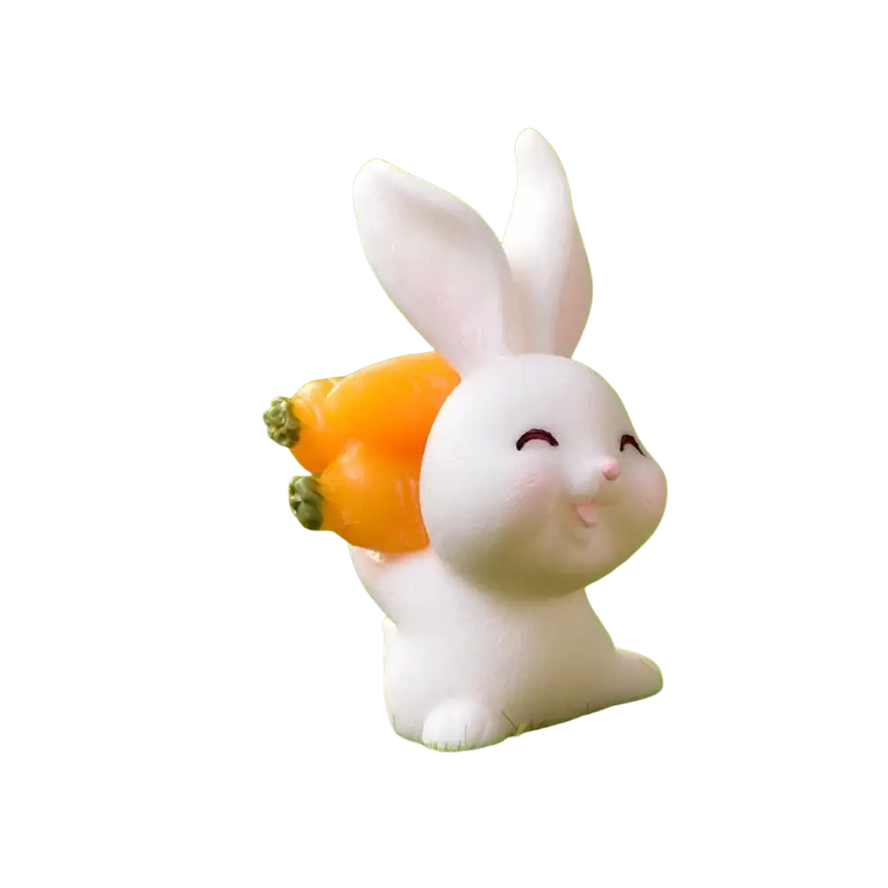 White ceramic resin bunny figurine holding an orange carrot ideal for easter garden and cake decor
