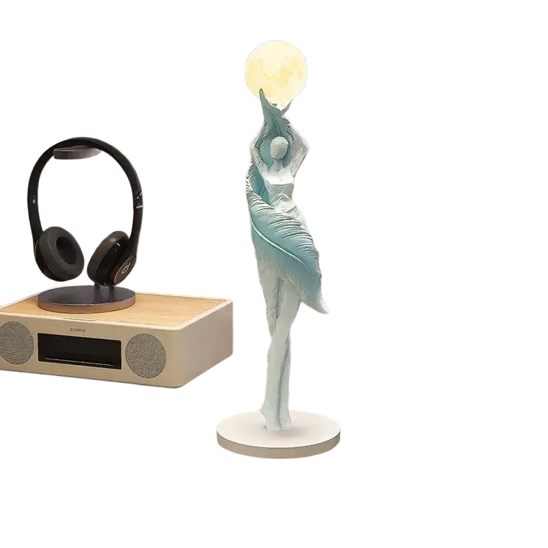 A delicate light blue resin dancer figurine 12x12x40cm holding a glowing orb on a white base for display effects