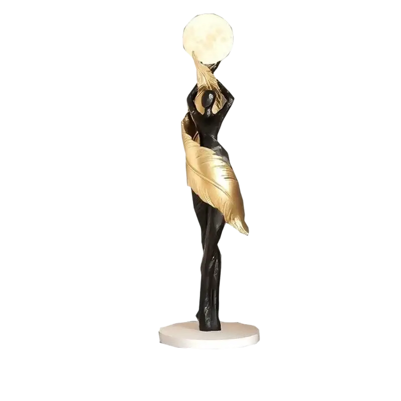 A sleek black and gold resin dancer figurine 12x12x40cm holding a round moon on a white base for modern display effects