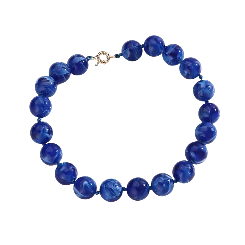 Resin geometric marbled beaded choker necklace in vibrant royal blue with swirling patterns and gold-toned clasp