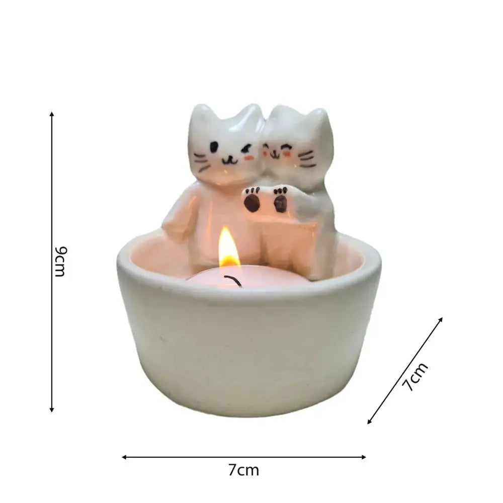 Handcrafted cuddling kittens white ceramic candle holder with two stylized cats black facial details and brown paw prints