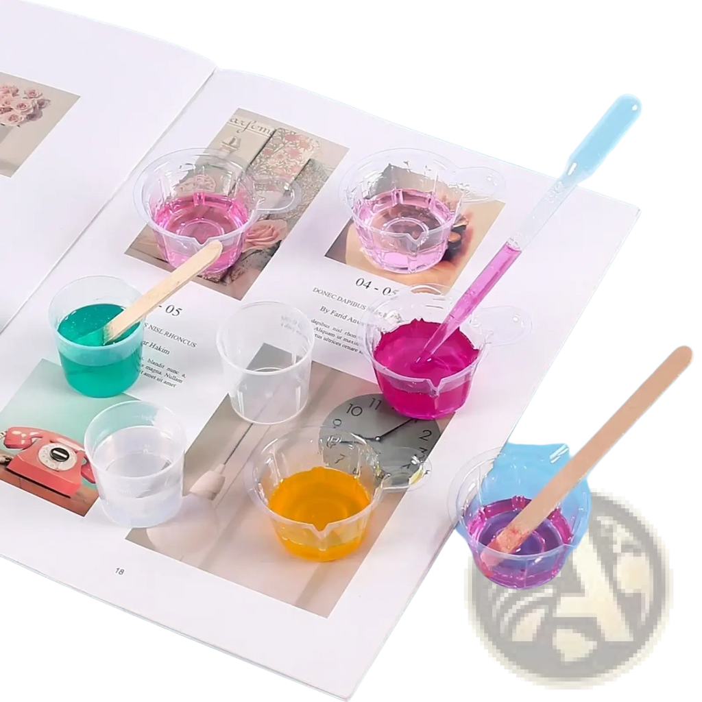 Clear plastic cups with colorful liquids and wooden stirrers in a resin mixing casting tools kit for jewelry making