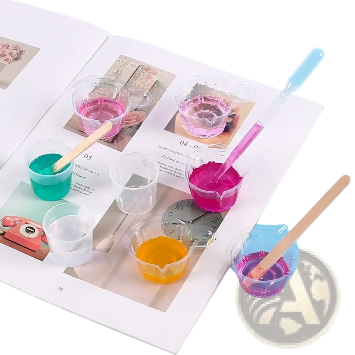 Clear plastic cups with colorful liquids and wooden stirrers in a resin mixing casting tools kit for jewelry making