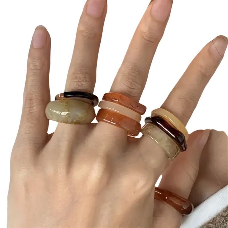 Set of chunky layered resin stackable rings in amber brown and cream showcasing bohemian retro style design