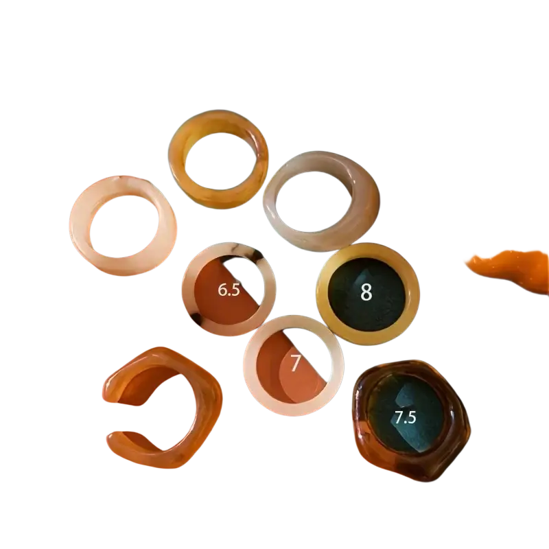 A bohemian retro style resin stackable ring set featuring hand-dyed translucent amber and beige tones in varying sizes