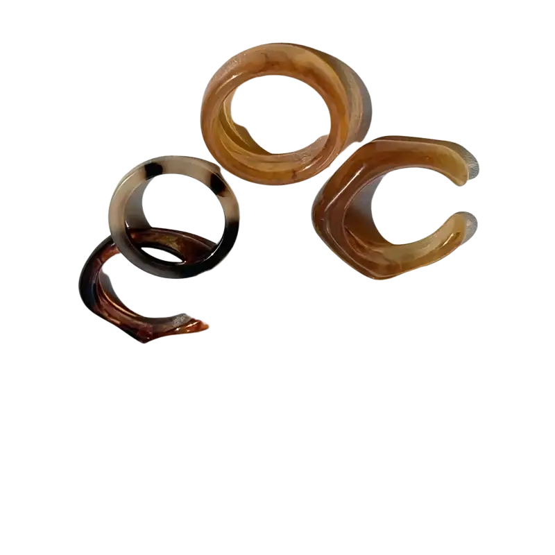 A set of translucent amber resin stackable rings in bohemian retro style with smooth glossy finish and varied shapes