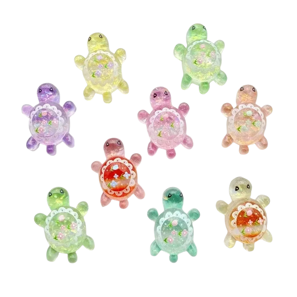 Pastel-colored resin turtle flatback charms with floral glitter details and lace-like borders 10 pack