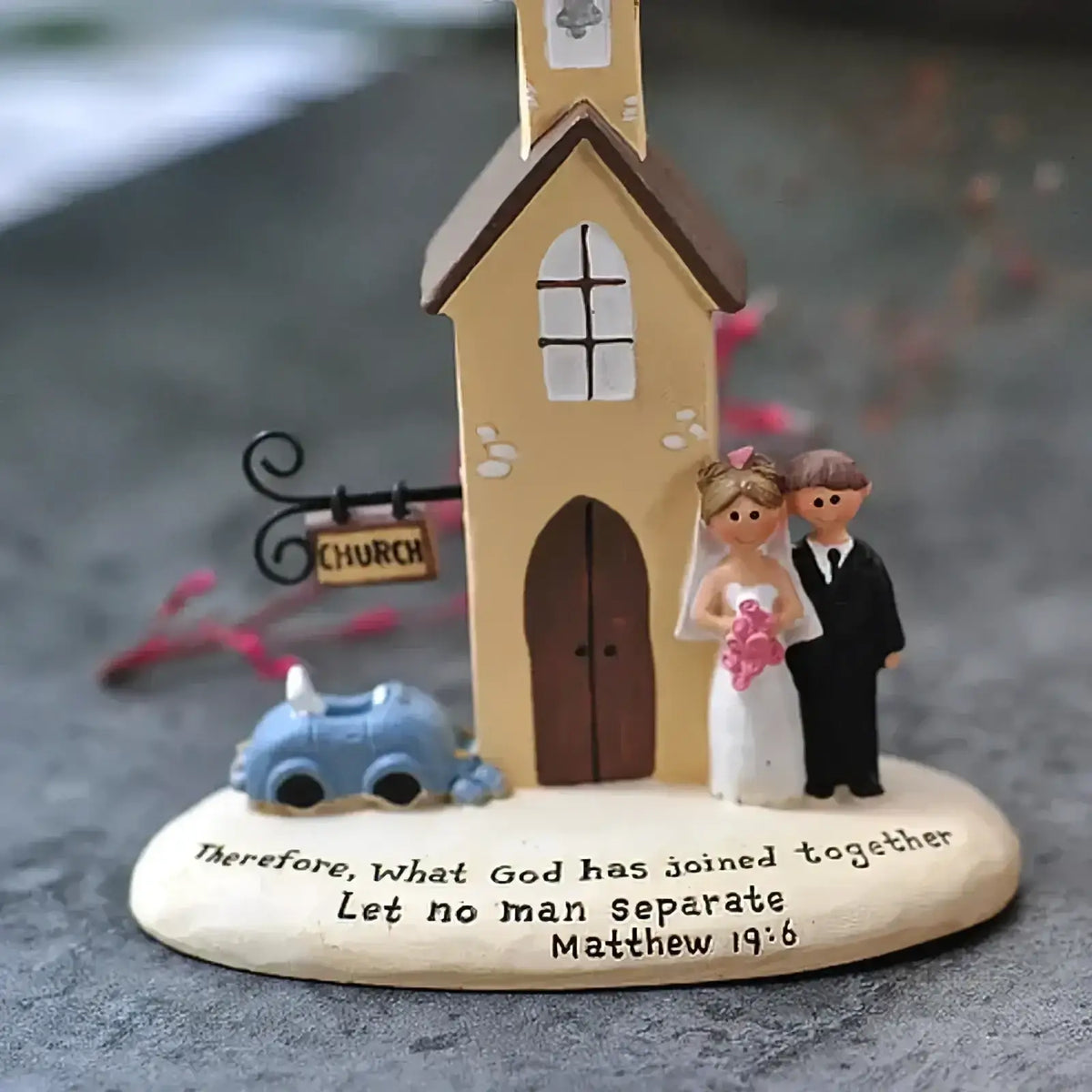 Yellow resin wedding church figurine with bride groom, brown roof trim, arched windows, and small blue car anniversary gift