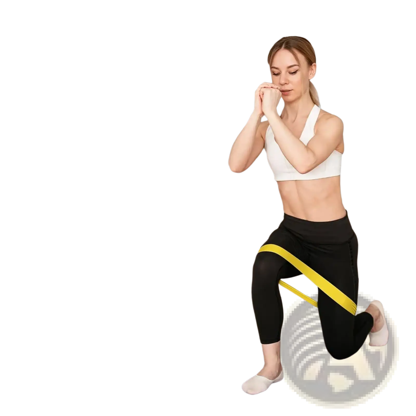 Yellow resistance band made of durable material worn around the woman’s knee for workout and pilates training