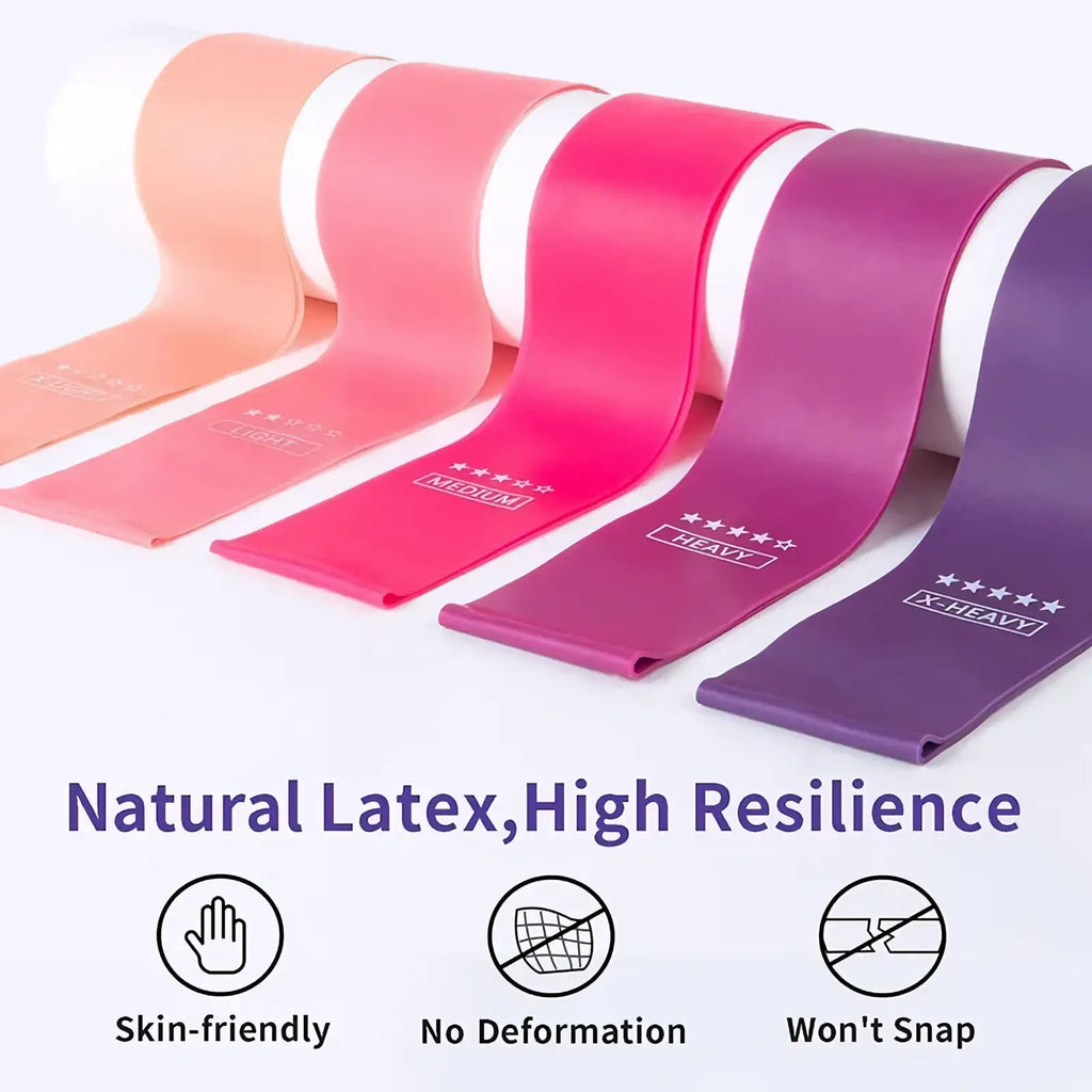 A set of five resistance loop exercise bands in gradient peach to deep purple with weight labels and smooth rubber texture
