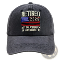 Dark gray distressed baseball cap with embroidered retirement 2025 text and american flag design