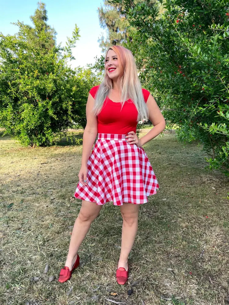 A red and white gingham flared pleated skirt paired with a vintage red boat neck cap sleeve top