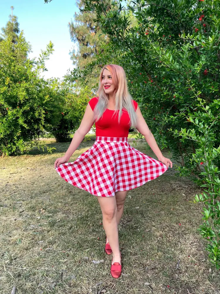 A red and white gingham flared a-line skirt paired with a vintage red boat neck cap sleeve top