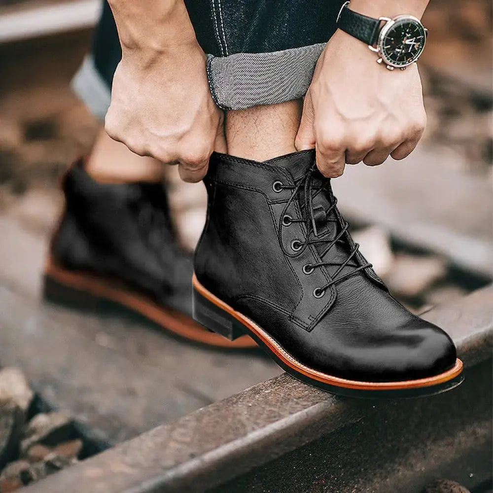 Men’s retro black leather lace-up ankle boot with contrasting tan sole and stitching for classic style and durability