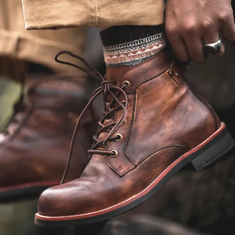 Men’s retro leather lace-up ankle boot in brown with rugged finish and contrasting red stitching along the sole