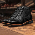 Men’s retro black leather chukka boots with a matte finish and contrasting tan stitching along the sole