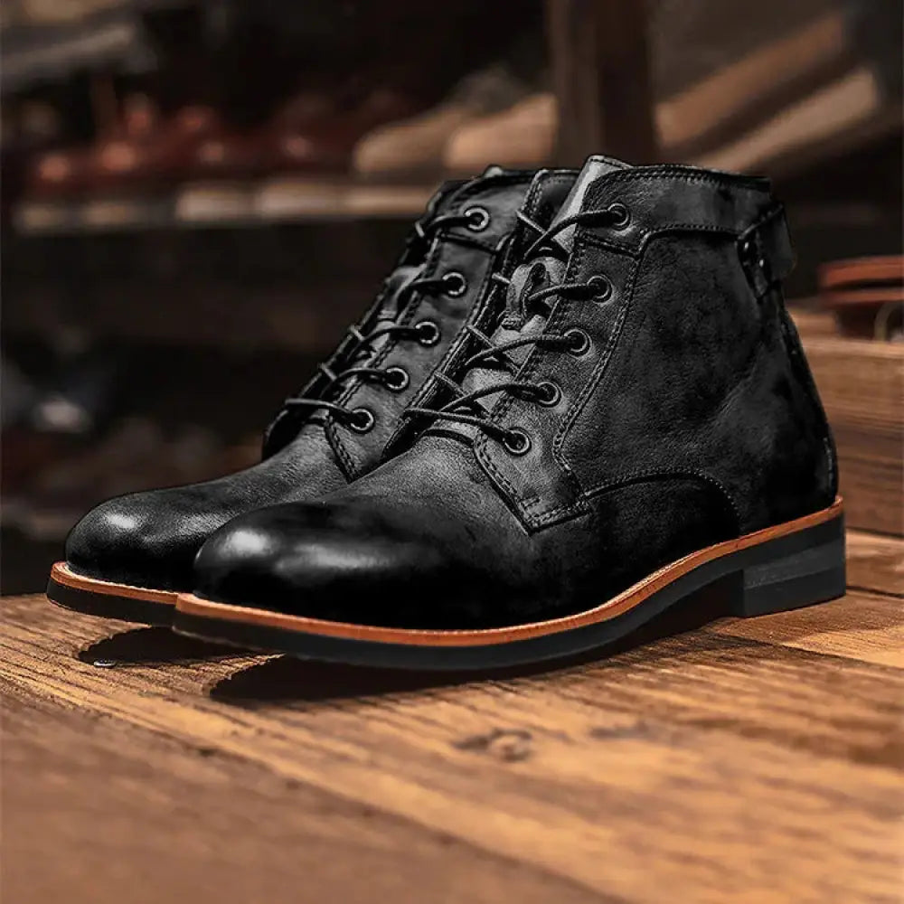 Men’s retro black leather chukka boots with a matte finish and contrasting tan stitching along the sole