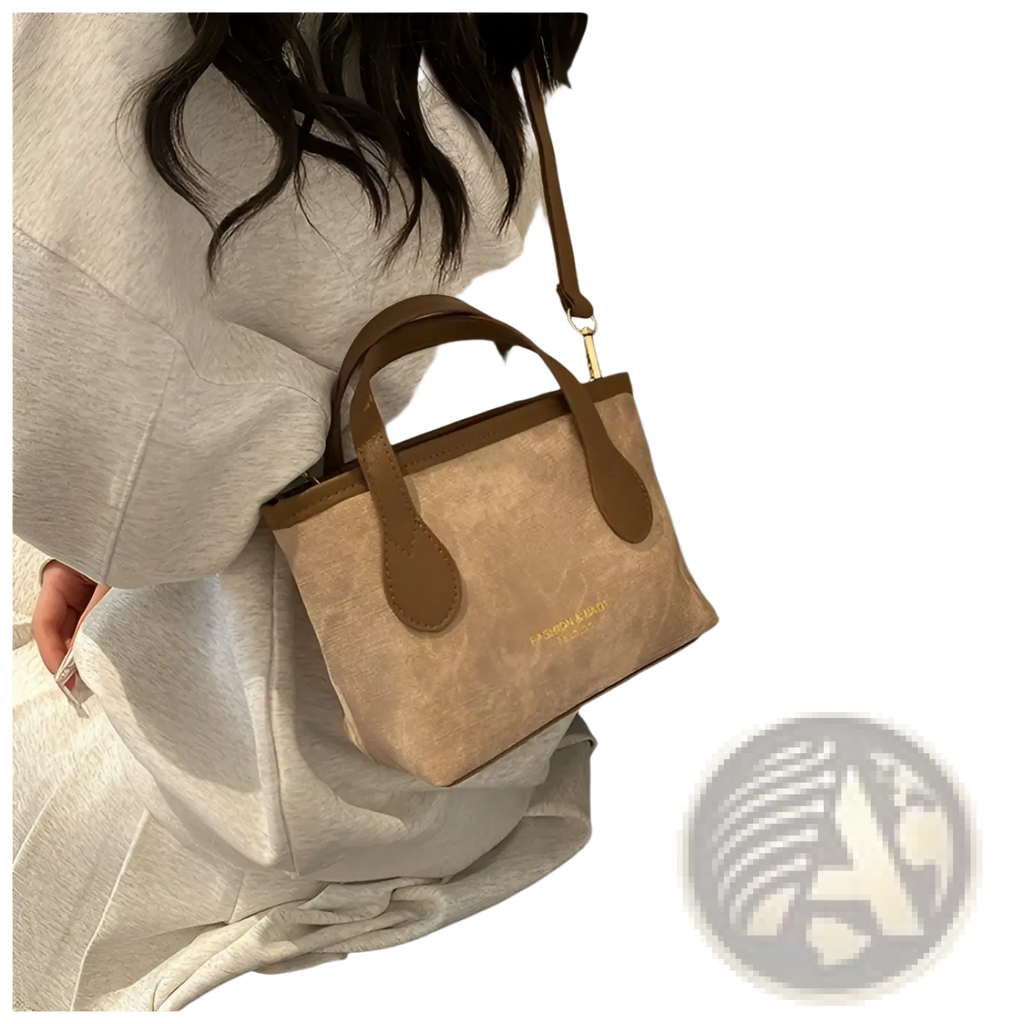 Beige canvas retro bucket bag mini tote with brown leather handles trim and subtle gold logo on the front