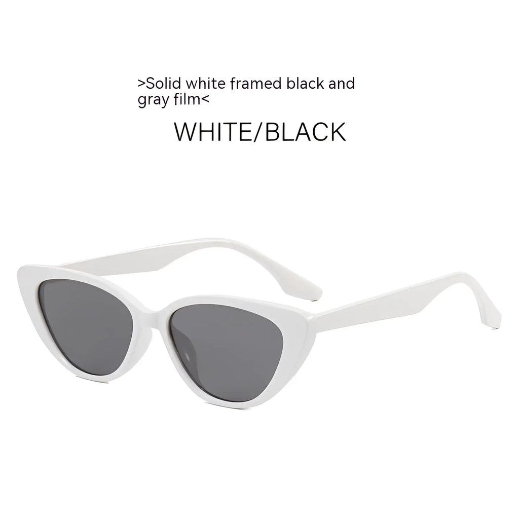 White-framed retro chic cat eye sunglasses with black and gray tinted lenses for stylish sun protection