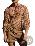 A man wearing a retro geometric sheer oversized vacation shirt with abstract warm tones in orange red and beige